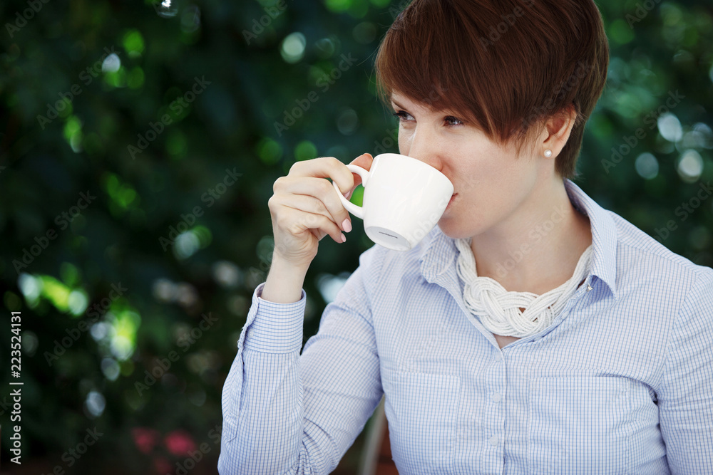 Young cute woman drinks coffee. Young cute woman drinks coffee.
