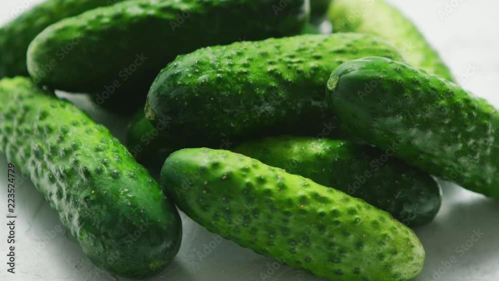 Closeup of textured pimply green cucumbers lying in small heap in soft daylight Closeup of textured pimply green cucumbers lying in small heap in soft daylight