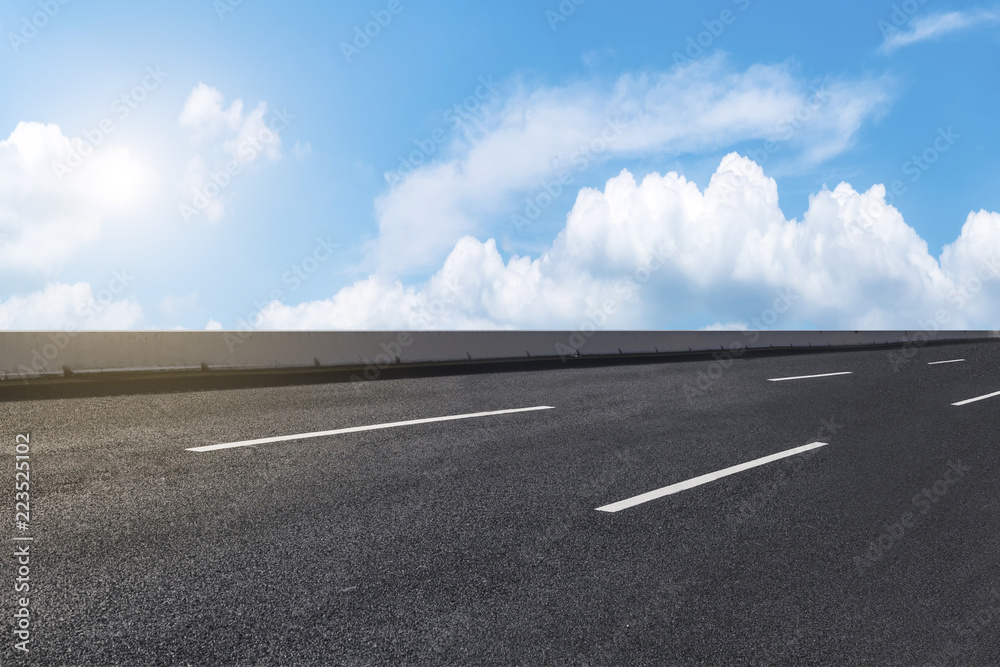 Road pavement under blue sky and white clouds Road pavement under blue sky and white clouds