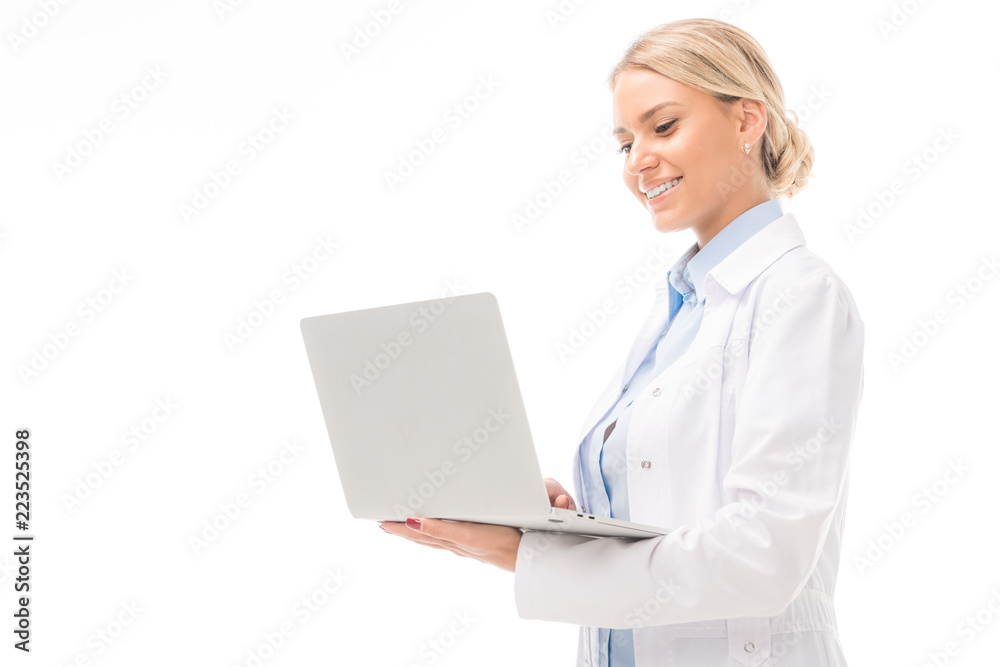 happy young female doctor working with laptop isolated on white happy young female doctor working with laptop isolated on white