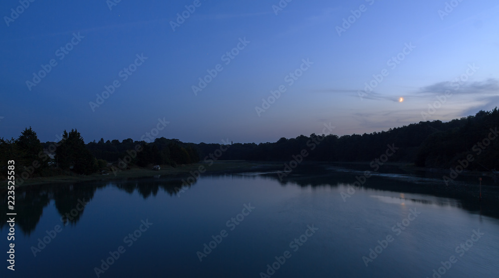 Beautiful dark blue nightscape landscape of the coastal river L'Arguenon after sunset with a new moon rising and reflection in the water near Saint-Malo in Brittany, France
Beautiful dark blue nightscape landscape of the coastal river L'Arguenon after sunset with a new moon rising and reflection in the water near Saint-Malo in Brittany, France