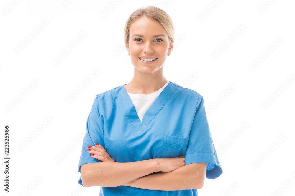 smiling young nurse with crossed arms looking at camera isolated on white - obrazy, fototapety, plakaty 