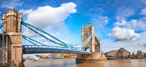 Tower Bridge in London, England, on a bright sunny day under gorgeous sky with clouds