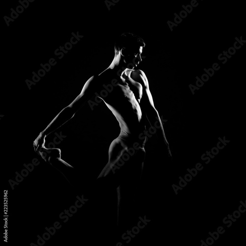 Black and white silhouette of male ballet dancer.