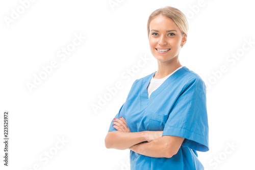 happy young nurse with crossed arms looking at camera isolated on white photo
