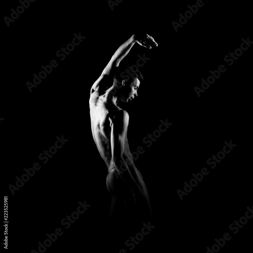 Black and white silhouette of male ballet dancer.