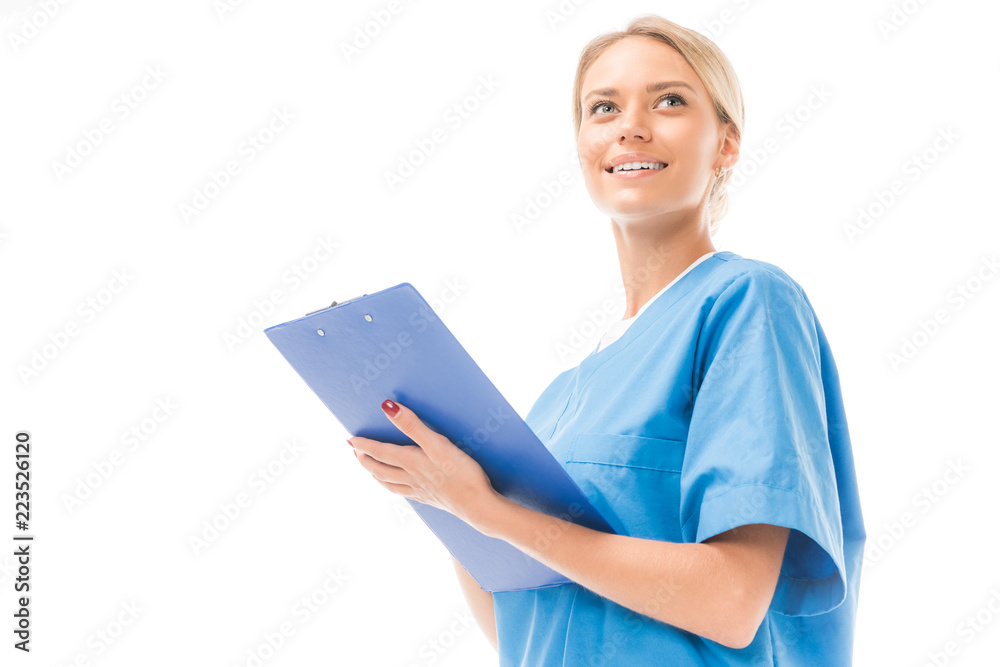 bottom view of smiling young nurse writing in clipboard isolated on white bottom view of smiling young nurse writing in clipboard isolated on white