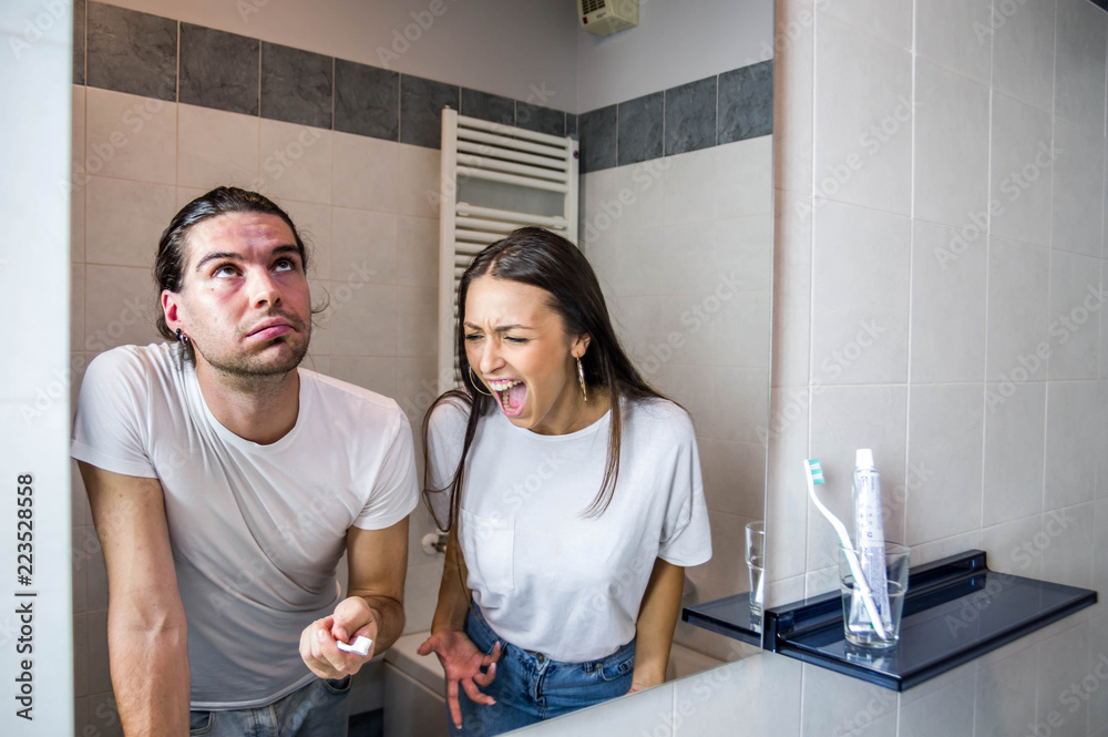 Couple in crisis fighting in the bathroom, angry girlfriend yelling at ...