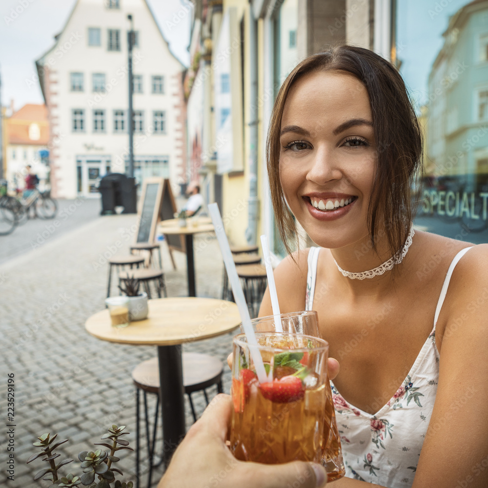 young brunette woman having ice tea