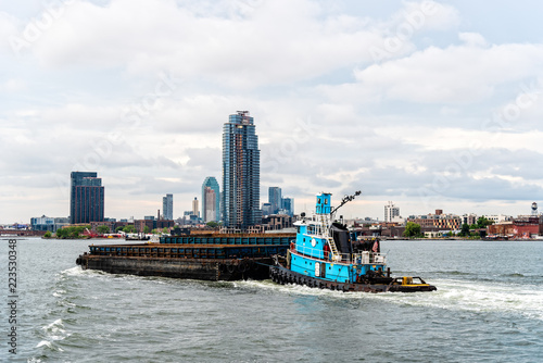 Tugboat pushing barge in New York City