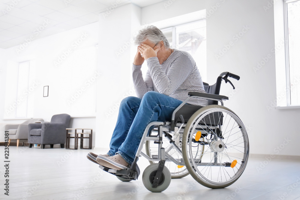 Depressed senior man in wheelchair at home Depressed senior man in wheelchair at home