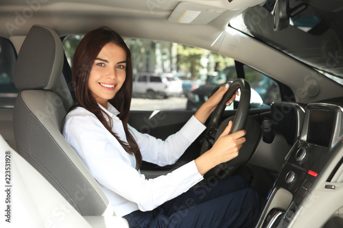 Young woman on driver's seat of car