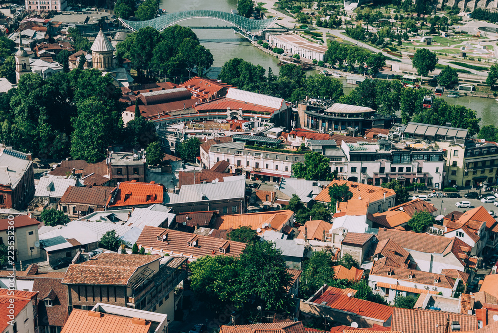 Panoramic view of Old Tbilisi, the capital of Georgia. Hot sunny afternoon. Red rooftops of old houses. Vintage colors