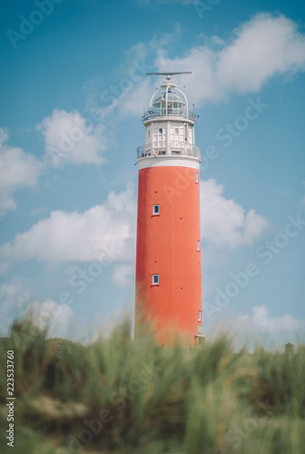 lighthouse with blue sky and white clouds
