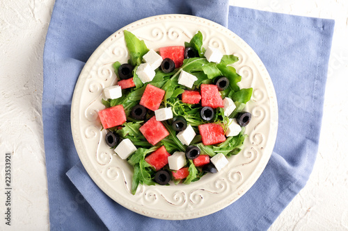 Plate with delicious watermelon salad on table