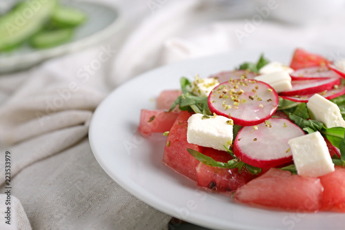 Plate with delicious watermelon salad on table, closeup
