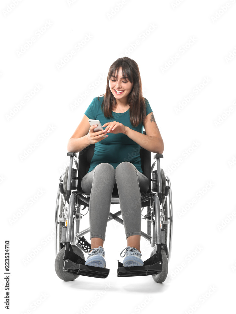 Young woman in wheelchair with mobile phone on white background Young woman in wheelchair with mobile phone on white background