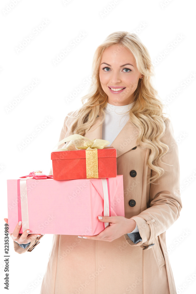 happy woman in beige autumn coat holding presents, isolated on white happy woman in beige autumn coat holding presents, isolated on white