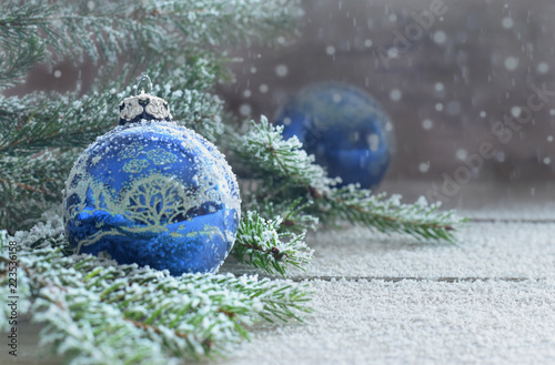 Christmas card with blue ball and snowing