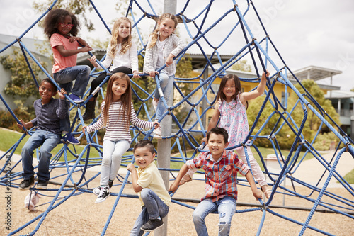 Canvas Print Elementary school kids climbing in the school playground