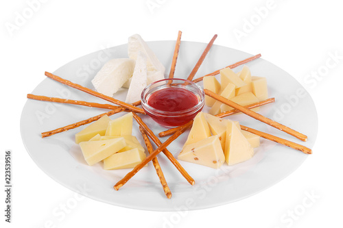 Snack to wine, sweet, a set of cheeses, jam, sweet, salty cookies, dough sticks aperitif before alcohol, food on plate, white isolated background Side view. For the menu, restaurant, bar, cafe photo