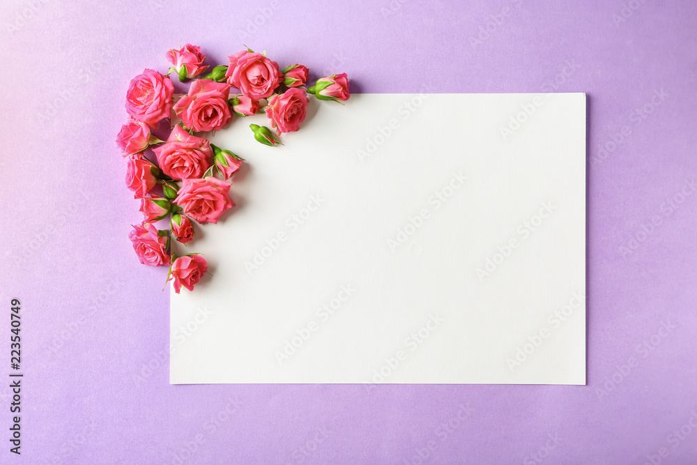 Beautiful blooming flowers and empty card on color background