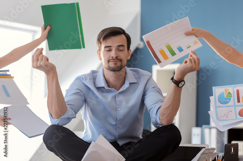 Принти на полотні Businessman with a lot of work to do meditating in office