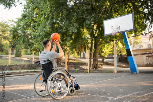 Young man in wheelchair pla...