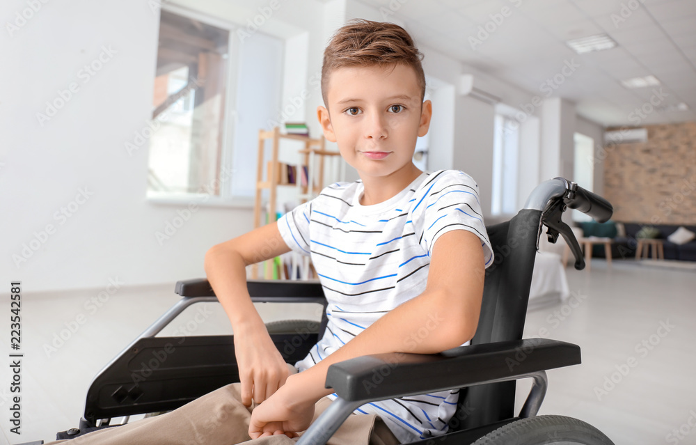 Handicapped boy in wheelchair at home Handicapped boy in wheelchair at home