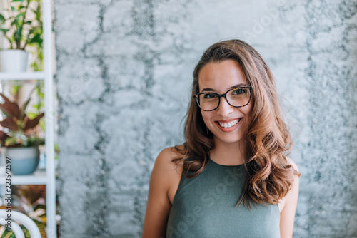 Headshot of gorgeous young woman with eyeglasses. photo