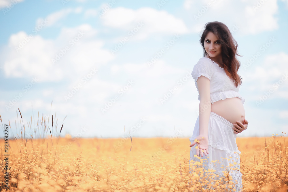 Pregnant woman in nature for a walk in the autumn Pregnant woman in nature for a walk in the autumn