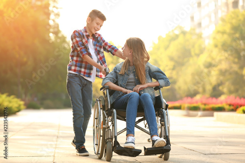 Teenage girl in wheelchair ...