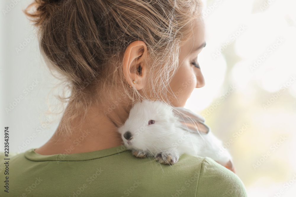 Beautiful young woman with cute rabbit at home Beautiful young woman with cute rabbit at home