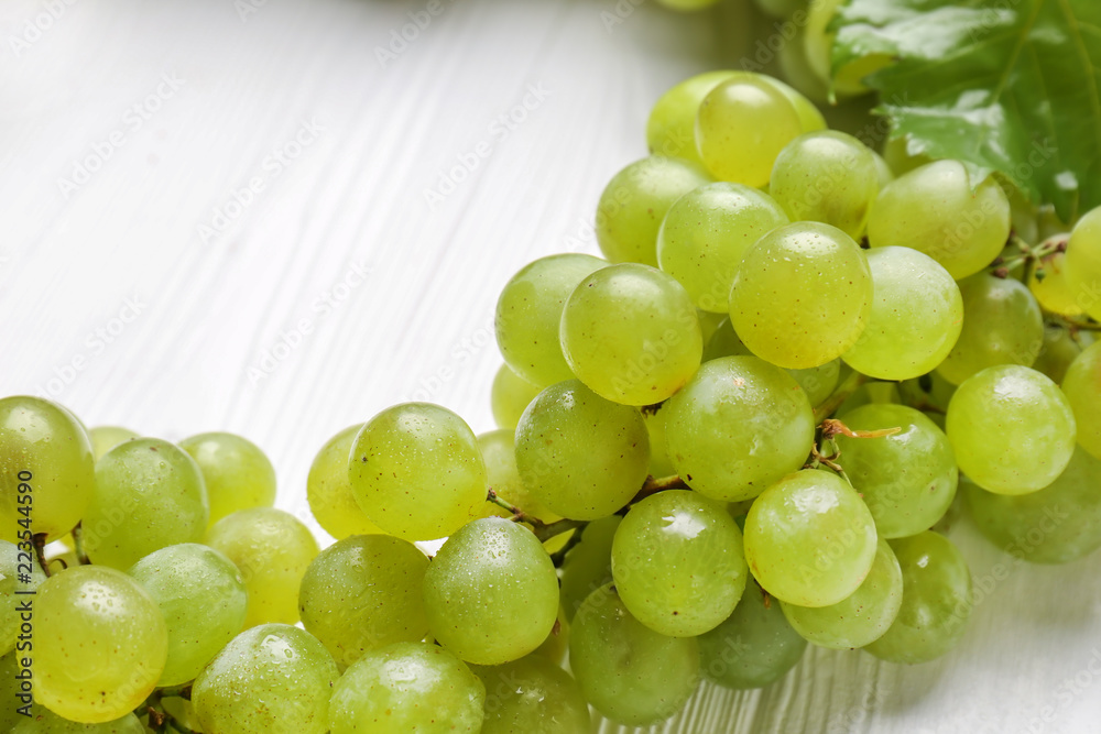 Ripe sweet grapes on white wooden table, closeup Ripe sweet grapes on white wooden table, closeup
