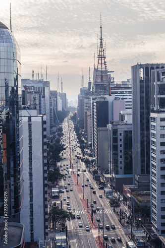 Aerial view of Paulista avenue on the afternoon in a cloudy day. Cars, avenues, commucation tower and business buildings compose the picture. Famous place, architecture and urban as a concept photo