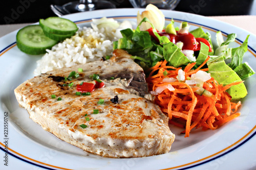 Grilled sword fish steak with vegetables, shallow focus