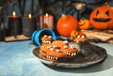 Creative cookies prepared for Halloween party on metal tray