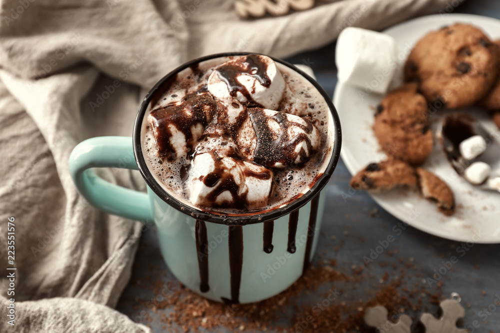 Metal cup of hot chocolate with marshmallows on table Metal cup of hot chocolate with marshmallows on table