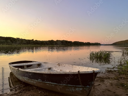 Tourist rubber boat on bank of mountain river