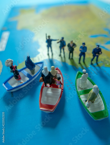 Miniature people concept of Middle Eastern people arrive by boat to the border of USA.