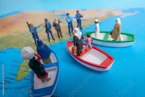 Miniature people concept of Middle Eastern people arrive by boat to the border of USA.