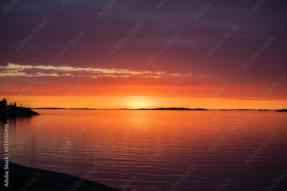 The setting sun on the Island of Aspö in Archipelago National Park (Skärgårdshavet nationalpark), Finland, 4 days after the summer solstice.