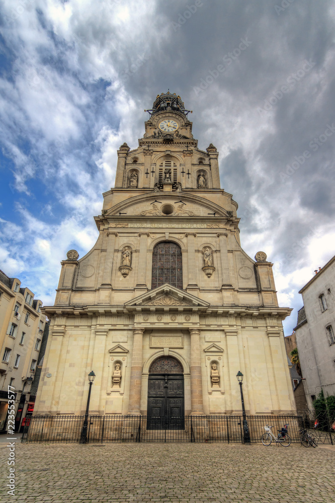 Beautiful wide angle view of the Église Sainte-Croix de Nantes in the city of Nantes, France, on a summer day with clouds