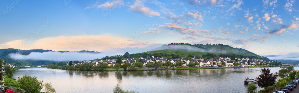 Beautiful 180 degree panoramic sunrise view of the river Moselle at the small wine growing town Zell (an der Mosel) on a summer morning Beautiful 180 degree panoramic sunrise view of the river Moselle at the small wine growing town Zell (an der Mosel) on a summer morning