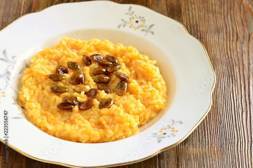 Creamy pumpkin risotto with caramelized pumpkin seeds, copy space