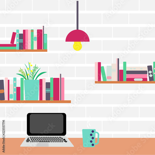 Workplace. Computer and bookshelves on a brick wall