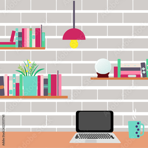 Workplace. Computer and bookshelves on a brick wall