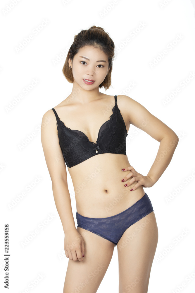 Chinese woman posing in panties and bra on white background Stock Photo