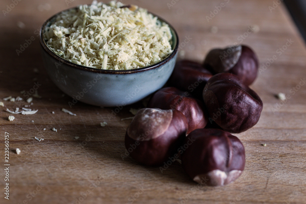 close up view of natural biological washing powder made of chestnuts in bowl on wooden table