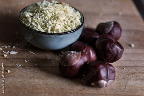 Obraz na płótnie close up view of natural biological washing powder made of chestnuts in bowl on wooden table w salonie